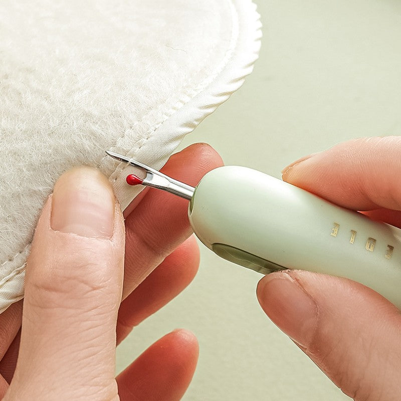 Seam ripper carefully removing a stitch